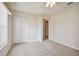 Bedroom with double door closet and ceiling fan at 11609 Weaver Park Ct, Trinity, FL 34655