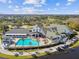 Community clubhouse with pool and palm trees at 11609 Weaver Park Ct, Trinity, FL 34655