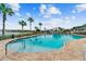 Community pool with lounge chairs and adjacent building at 11609 Weaver Park Ct, Trinity, FL 34655