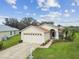 One-story house with a two-car garage, arched entry, and neatly landscaped yard at 11609 Weaver Park Ct, Trinity, FL 34655