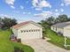 Single-story home with attached garage and well-manicured lawn at 11609 Weaver Park Ct, Trinity, FL 34655