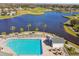 Resort-style pool with lake view and lounge chairs at 11609 Weaver Park Ct, Trinity, FL 34655