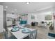 Open concept dining area with a white table and blue chairs at 1334 Fairmont St, Clearwater, FL 33755