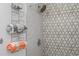 Updated shower with geometric patterned tile and metal towel rack at 1334 Fairmont St, Clearwater, FL 33755