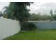 Private backyard with lush lawn and mature trees at 4313 Hollow Hill Dr, Tampa, FL 33624