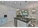 Modern kitchen with island, white cabinets, and view into living room at 806 Chipper Dr, Sun City Center, FL 33573