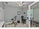 Home office with desk, exercise bike, and French doors leading to another room at 806 Chipper Dr, Sun City Center, FL 33573