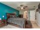 Main bedroom with dark wood furniture and teal accent wall at 9911 Golden Loop, New Port Richey, FL 34654