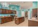 Bright kitchen with island, teal walls, and wood cabinets at 9911 Golden Loop, New Port Richey, FL 34654