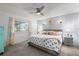 Relaxing main bedroom features a ceiling fan, two wall lamps, and a window with natural light at 1429 Monte Lake Dr, Valrico, FL 33596