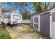 Spacious RV parking area next to a shed, offering ample room for recreational vehicles at 1429 Monte Lake Dr, Valrico, FL 33596