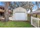 A backyard storage shed featuring a large door, an overhang, and a secure locking mechanism at 1429 Monte Lake Dr, Valrico, FL 33596