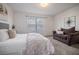 Bright bedroom with a comfortable bed and sitting area at 2553 Harn Blvd # 5, Clearwater, FL 33764