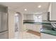 Well-lit kitchen featuring white cabinets and green countertops at 7506 Cumber Dr, New Port Richey, FL 34653