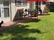 Green lawn and a stone patio area with outdoor seating and dining options at 3157 Mission Grove Dr, Palm Harbor, FL 34684