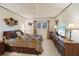 Comfortable bedroom with ceiling fan, window and a dresser with a TV at 3157 Mission Grove Dr, Palm Harbor, FL 34684