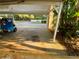 Covered parking area and tropical garden at 3157 Mission Grove Dr, Palm Harbor, FL 34684