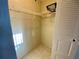 A closet with ample storage space featuring shelving, rod, and tile floor at 3157 Mission Grove Dr, Palm Harbor, FL 34684