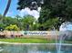 Community entrance sign with beautiful landscaping, water feature, and welcoming design for the active adult community at 3157 Mission Grove Dr, Palm Harbor, FL 34684