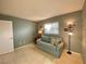 Comfortable room with a couch, side table, floor lamp and wall decor at 3157 Mission Grove Dr, Palm Harbor, FL 34684
