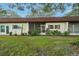 Charming home exterior with well-maintained landscaping and a cozy front porch at 3157 Mission Grove Dr, Palm Harbor, FL 34684