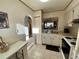 Open kitchen featuring a pass-through to the living area and white appliances at 3157 Mission Grove Dr, Palm Harbor, FL 34684