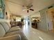 Bright living room with tile flooring, ceiling fan, and an open layout at 3157 Mission Grove Dr, Palm Harbor, FL 34684