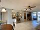 Inviting living room with tile floors, ceiling fan, neutral walls, and access to a screened patio at 3157 Mission Grove Dr, Palm Harbor, FL 34684
