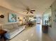 Inviting living room featuring a ceiling fan, tile flooring, and comfortable seating at 3157 Mission Grove Dr, Palm Harbor, FL 34684