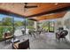 Enclosed patio with ceiling fans, and comfortable seating, overlooking the pool area at 3157 Mission Grove Dr, Palm Harbor, FL 34684