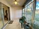 Screened patio with a ceiling fan, tiled floor, and view of the outdoors at 3157 Mission Grove Dr, Palm Harbor, FL 34684