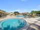 Resort-style pool area with multiple pools, lounge chairs, tables, and well-maintained surroundings at 3157 Mission Grove Dr, Palm Harbor, FL 34684