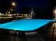 A relaxing community pool with night lighting at 3157 Mission Grove Dr, Palm Harbor, FL 34684