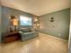 Inviting spare room with neutral walls, tile flooring, and a comfortable blue sofa at 3157 Mission Grove Dr, Palm Harbor, FL 34684