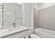 Bathroom with white vanity, gray tile, and a bathtub at 1692 Fallon Pass, Zephyrhills, FL 33541