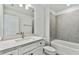 Bathroom with white vanity, grey tile, and a bathtub at 1692 Fallon Pass, Zephyrhills, FL 33541