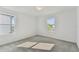 Well-lit bedroom with grey carpet and two windows at 1692 Fallon Pass, Zephyrhills, FL 33541