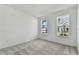 Bright bedroom with gray carpet and two large windows at 1692 Fallon Pass, Zephyrhills, FL 33541