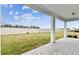 Spacious covered patio overlooking a fenced backyard at 1692 Fallon Pass, Zephyrhills, FL 33541