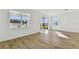 Spacious living room with wood-look tile flooring and sliding glass doors at 1692 Fallon Pass, Zephyrhills, FL 33541