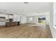 Spacious living room with wood-look tile flooring and sliding glass doors at 1692 Fallon Pass, Zephyrhills, FL 33541