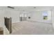 Spacious loft area with grey carpet and large windows at 1692 Fallon Pass, Zephyrhills, FL 33541