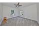 Bright bedroom with neutral carpeting and two large windows at 415 Islebay Dr, Apollo Beach, FL 33572