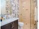 Stylish bathroom with marble vanity, walk-in shower, and palm tree wallpaper at 4923 W Melrose N Ave, Tampa, FL 33629