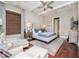 Spacious bedroom with a comfortable bed, sitting area, and hardwood floors at 4923 W Melrose N Ave, Tampa, FL 33629