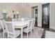 Bright dining room with a large table, eight chairs, and hardwood floors at 4923 W Melrose N Ave, Tampa, FL 33629
