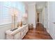 Light and airy hallway with hardwood floors and stylish decor at 4923 W Melrose N Ave, Tampa, FL 33629