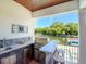 Outdoor kitchen with granite countertops and built-in grill overlooking canal at 4923 W Melrose N Ave, Tampa, FL 33629