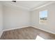 Bedroom with wood-look floors, crown molding, and a large window at 12977 Long Valley Cir, Spring Hill, FL 34609