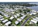 Aerial view of a large community with many mobile homes and a waterfront at 15 Hamilton Ln # 7, Palm Harbor, FL 34684